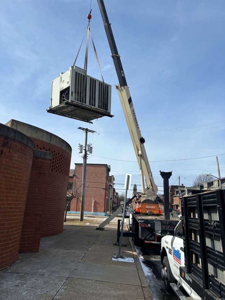 Denillo team installing AC unit