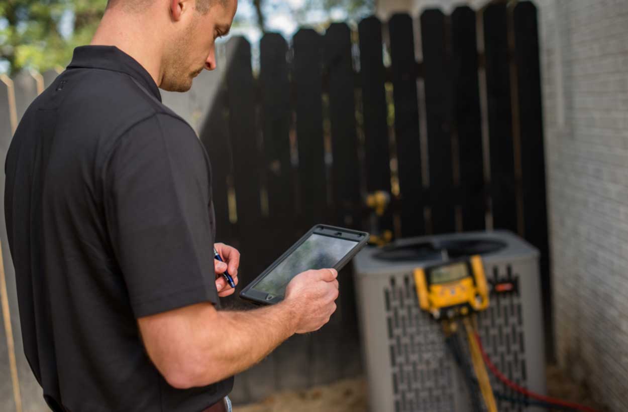 Tech working on Trane unit